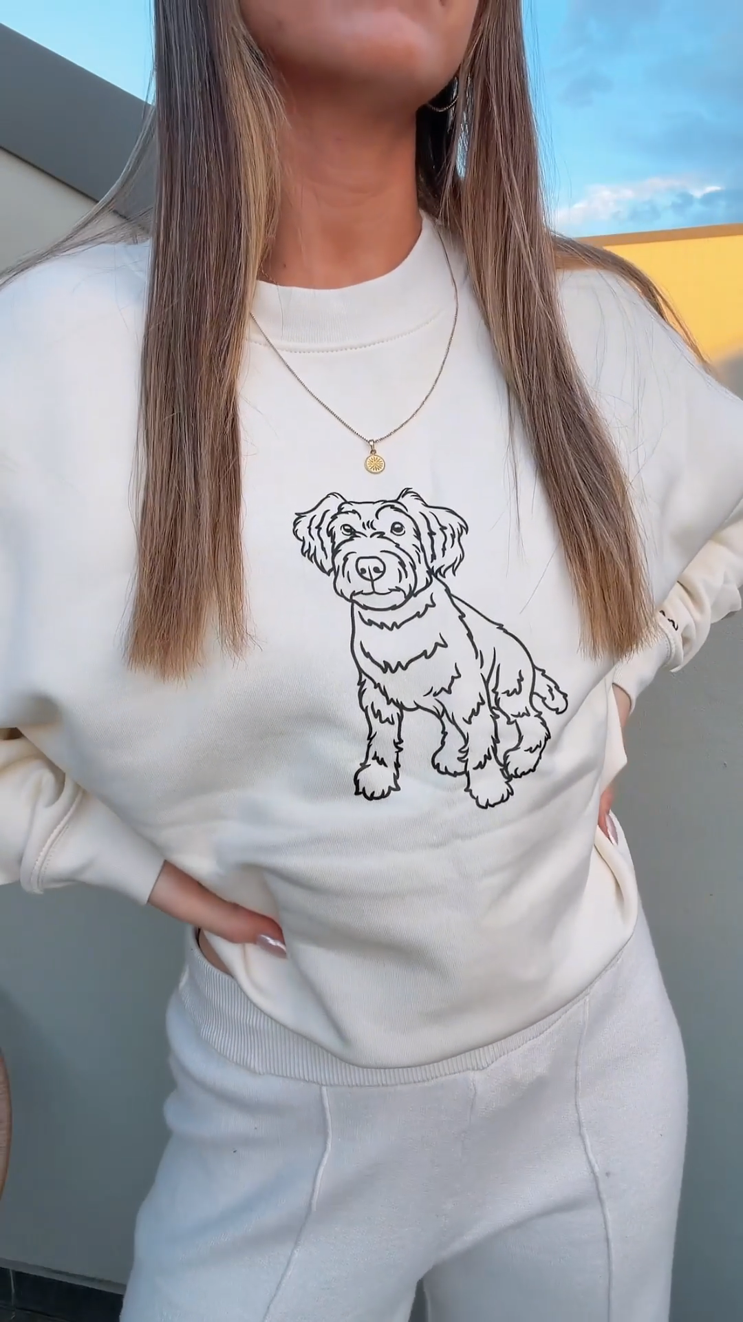 Woman wearing custom outline print crewneck with hand-drawn pet portrait